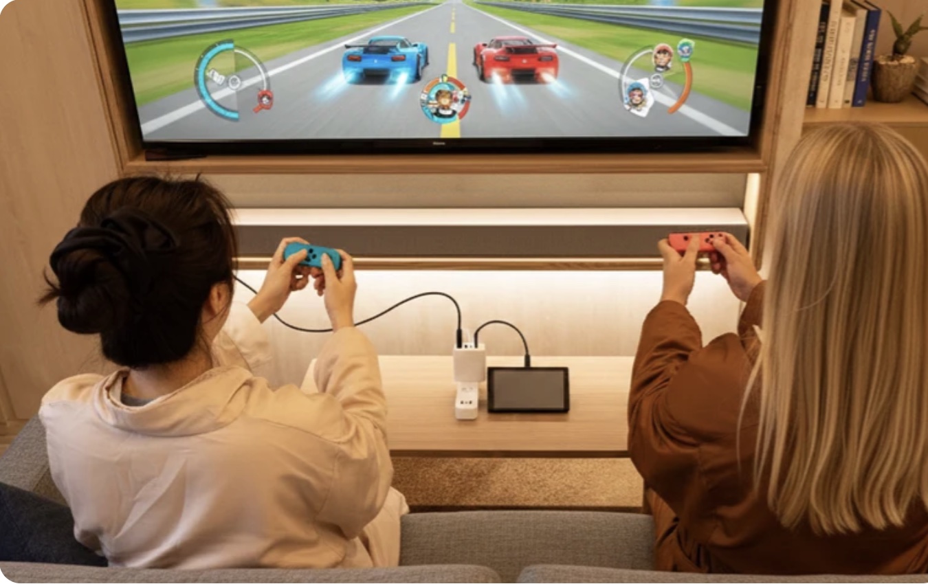 Two people playing Nintendo Switch on a television connected through Bricbloc